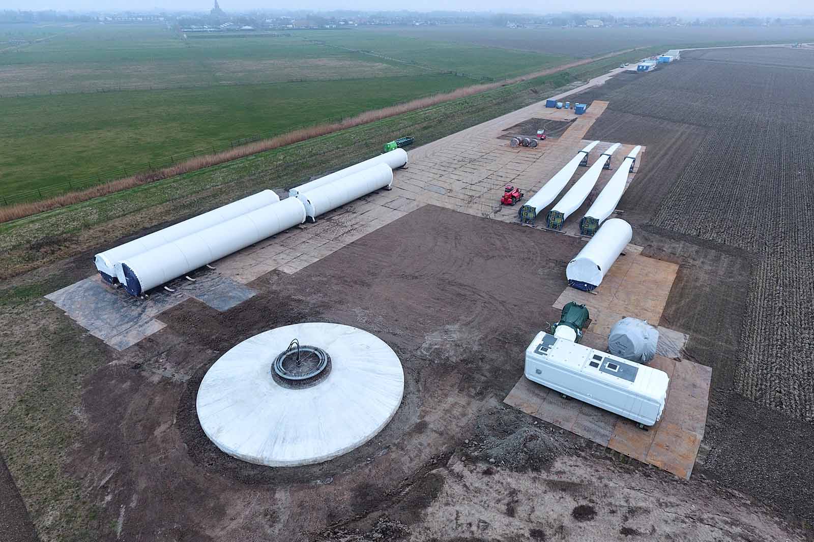 Aerial view of wind turbine tower sections blades and foundation